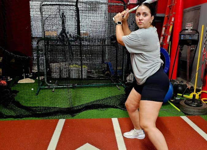 woman about to hit a baseball