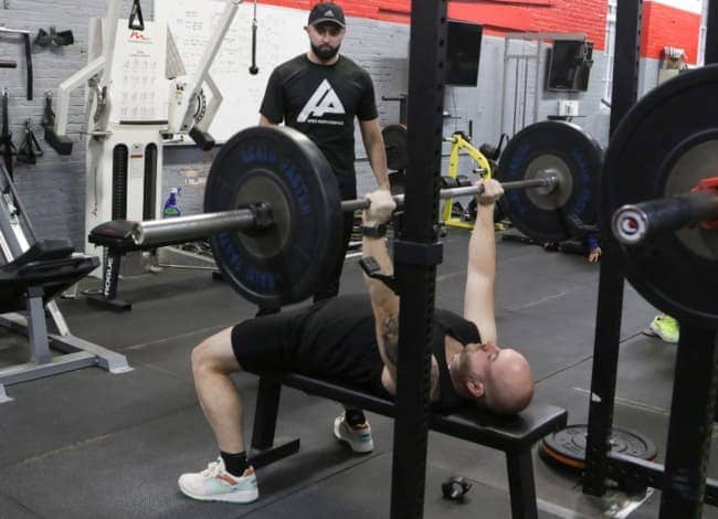 woman using resistance bands in a gym